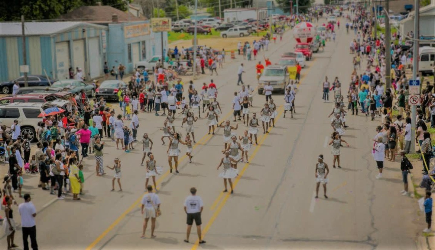 Crowds lining a North Omaha street during the Native Omaha Days homecoming parade