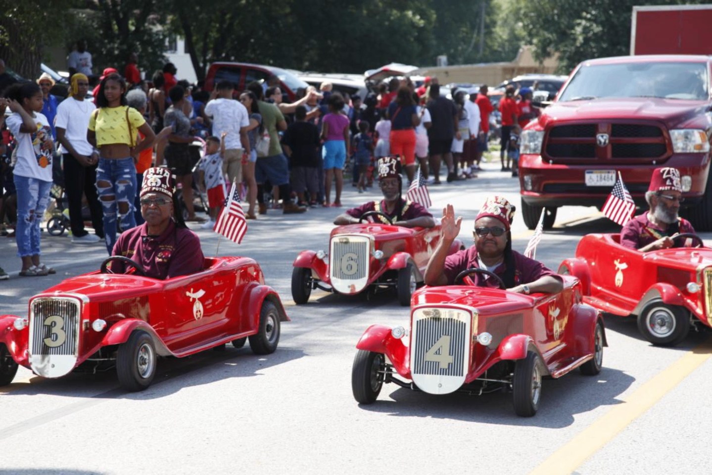 Shriners driving miniature cars in the homecoming parade